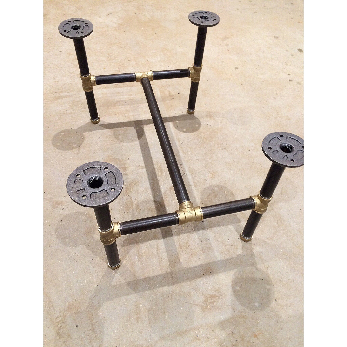 Black steel pipe legs with brass accents